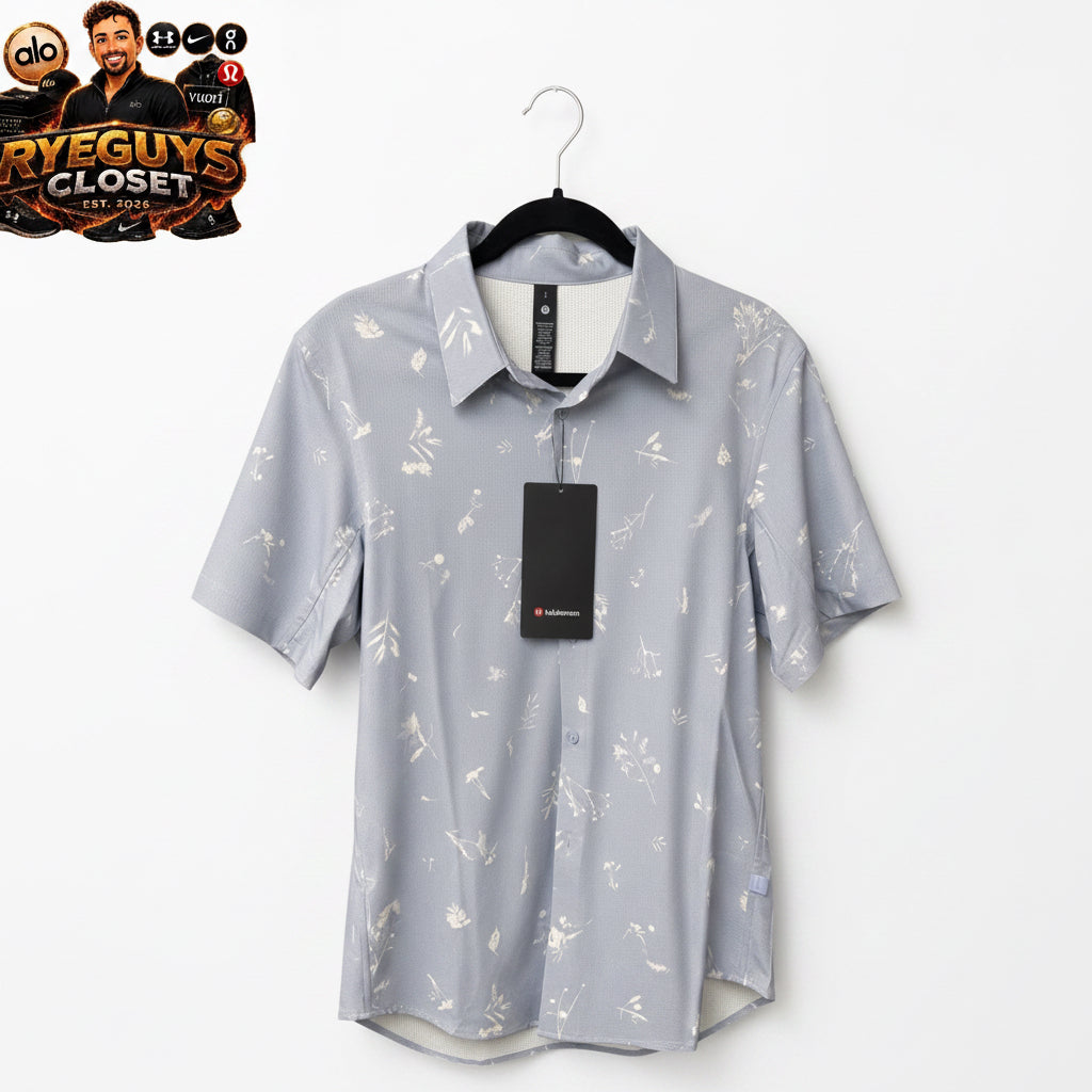 Gray short-sleeve shirt with white floral pattern on a hanger against a brown background, featuring Ryeguys Closet branding.